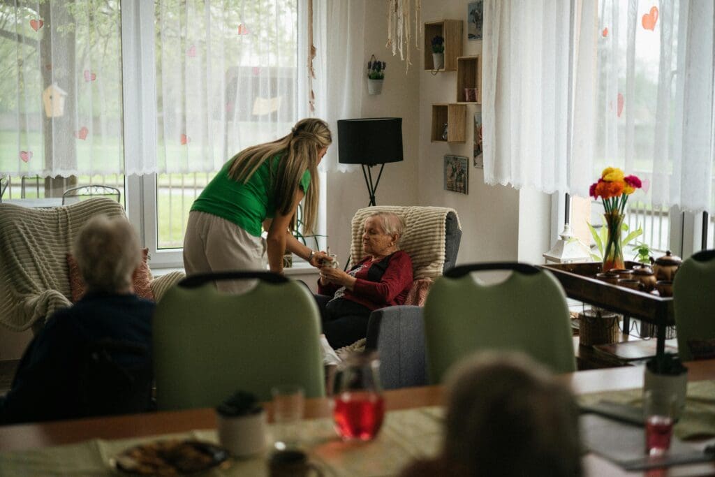 A nurse helping an elderly person with Long Term Care Insurance in California